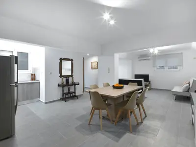 a kitchen and dining room with a table and chairs at 2 bedroom aprtmnt next to Hilton and all hospitals in Athens