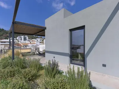 a house with a large window on the side of it at Luxury Acropolis Rooftop Apartment in Athens