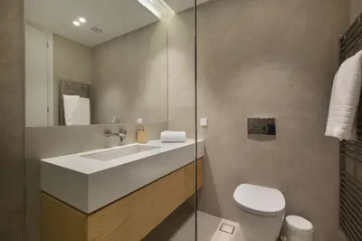 a bathroom with a white sink and a toilet at Luxury Acropolis Rooftop Apartment in Athens