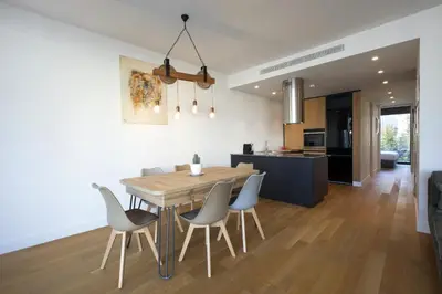 a kitchen and dining room with a wooden table and chairs at Luxury Acropolis Rooftop Apartment in Athens