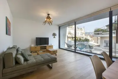 a living room with a couch and a large window at Luxury Acropolis Rooftop Apartment in Athens
