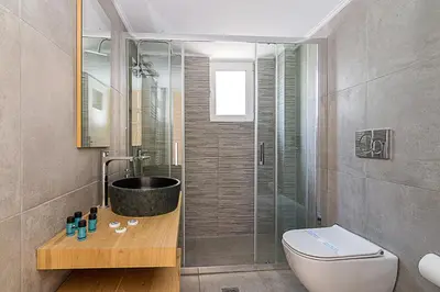 a bathroom with a shower and a toilet and a sink at Two Bedroom Apartment in Chalandri with Balcony in Athens
