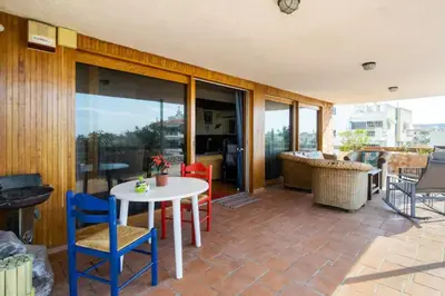 a patio with a white table and chairs at Elena's Athenian Penthouse in Athens