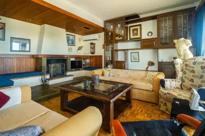 a living room with a couch and a table at Elena's Athenian Penthouse in Athens