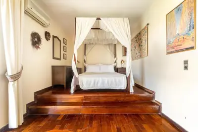 a bedroom with a bed with a canopy at Elena's Athenian Penthouse in Athens