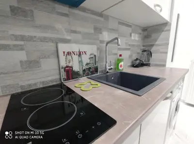 a kitchen counter with a sink and a stove at Modern apartment with a huge terrace in Athens