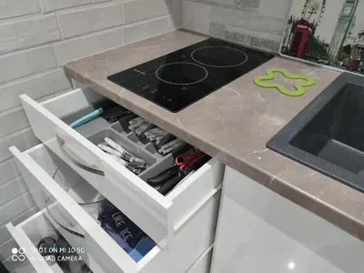 a kitchen counter with a stove top on it at Modern apartment with a huge terrace in Athens