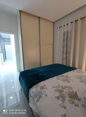 a bedroom with a bed with a blue blanket on it at Modern apartment with a huge terrace in Athens