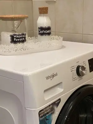 a washing machine with a bottle on top of it at Elegant Glyfada Apartment-private Garden-Near METRO in Athens