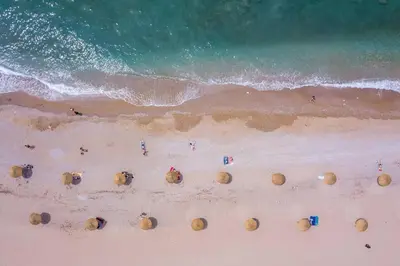 an aerial view of a beach with people on the sand at Elegant Glyfada Apartment-private Garden-Near METRO in Athens