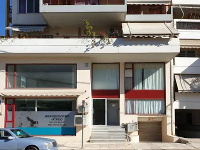 a building with a car parked in front of it at KYMA Apartments Athens 18 in Athens