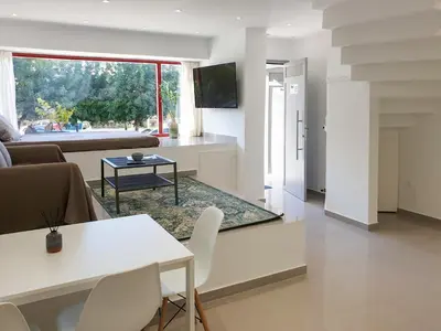 a living room with a couch and a table at KYMA Apartments Athens 18 in Athens