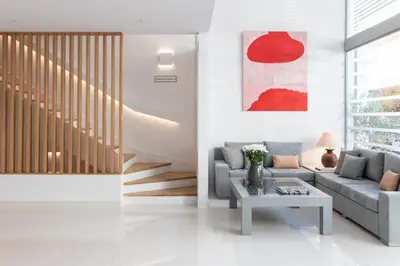 a living room with a couch and a table at Gallery Suites & Residences Piraeus in Piraeus