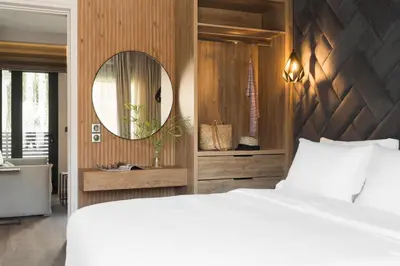a bedroom with a white bed and a mirror at LUX&EASY Athens Downtown Apartments in Athens