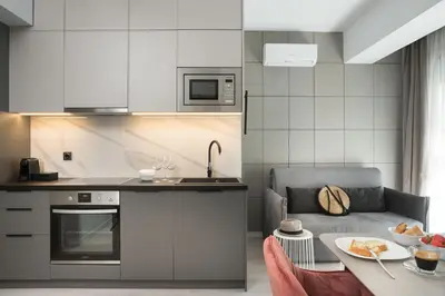 a kitchen with a couch and a table in a room at LUX&EASY Athens Downtown Apartments in Athens