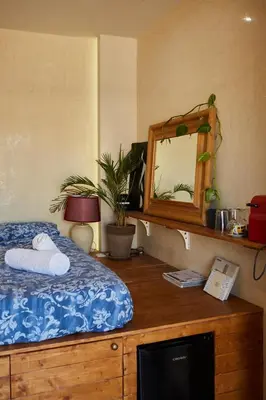 a bedroom with a bed and a mirror on a dresser at Mosaics Athens Penthouse with Acropolis view in Athens