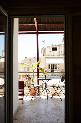 a view of a patio with a table and chairs at Mosaics Athens Penthouse with Acropolis view in Athens