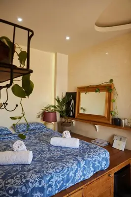a bedroom with a blue bed with towels on it at Mosaics Athens Penthouse with Acropolis view in Athens