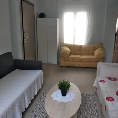 a living room with a couch and a table at CENTRAL TOWN HOUSE 60m2**** in Piraeus