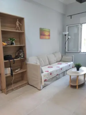 a living room with a couch and a table at CENTRAL TOWN HOUSE 60m2**** in Piraeus