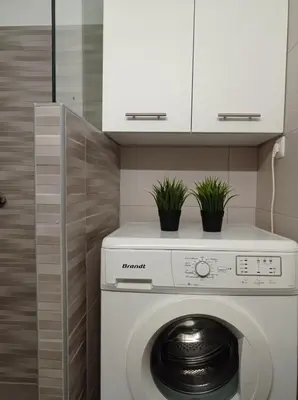 a washing machine in a kitchen with potted plants at CENTRAL TOWN HOUSE 60m2**** in Piraeus