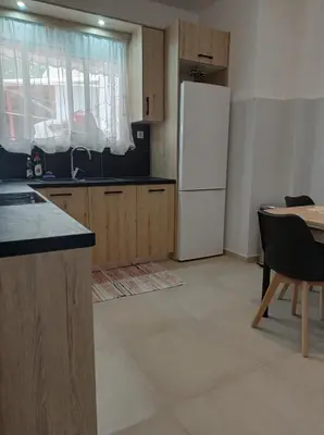 a kitchen with a white refrigerator and a table at CENTRAL TOWN HOUSE 60m2**** in Piraeus