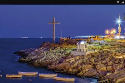 a cross on a rocky island with boats in the water at CENTRAL TOWN HOUSE 60m2**** in Piraeus