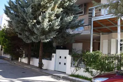 a pine tree in front of a house at h2h Anthi #Comfort apt near Athens in Athens