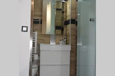 a bathroom with a white sink and a mirror at h2h Anthi #Comfort apt near Athens in Athens