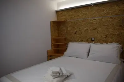 a white bed with a towel on top of it at h2h Anthi #Comfort apt near Athens in Athens