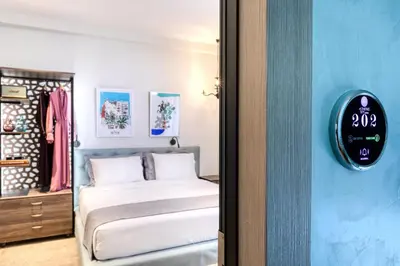 a bedroom with a bed and a clock on the wall at Athens Ivy Suites in Athens