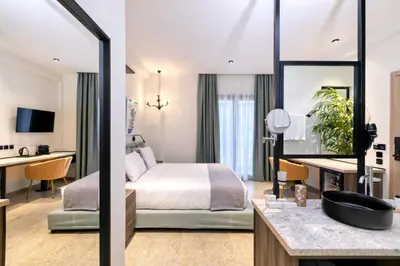 a hotel room with a bed and a desk at Athens Ivy Suites in Athens