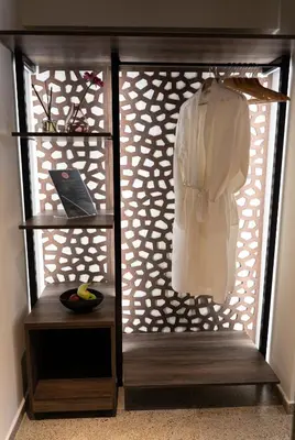 a closet with a white shirt hanging on a rack at Athens Ivy Suites in Athens