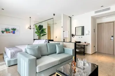 a living room with a couch and a bed at Athens Ivy Suites in Athens