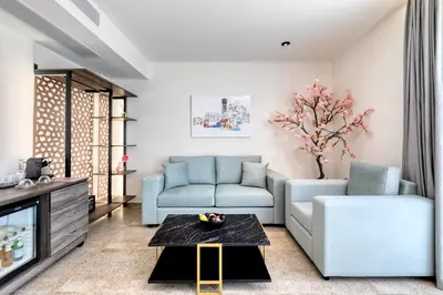a living room with a couch and a table at Athens Ivy Suites in Athens