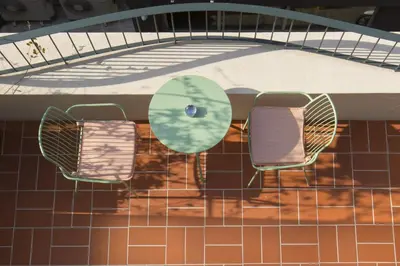 two chairs and a table in a swimming pool at L'Avventura Athens in Athens