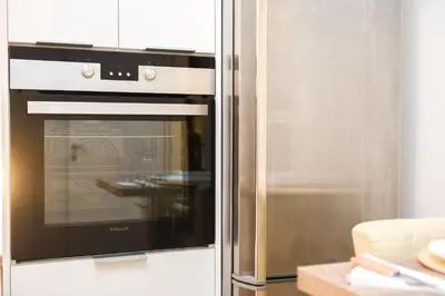 a stainless steel refrigerator with an oven in a kitchen at Acropolis Sweet House 2 in Athens