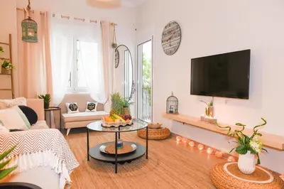 a living room with a couch and a tv at Acropolis Sweet House 2 in Athens