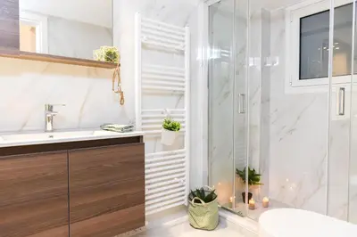 a bathroom with a shower and a sink at Acropolis Sweet House 2 in Athens