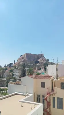 a view of a mountain from the roofs of buildings at Plaka Sweet House 2 in Athens