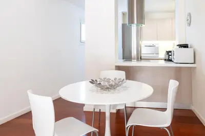 a white dining room table and chairs in a kitchen at Plaka Sweet House 2 in Athens