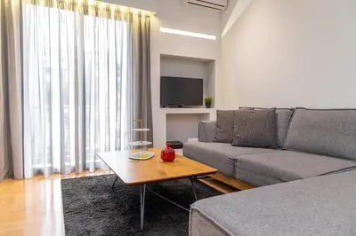 a living room with a couch and a table at Plaka Sweet House 1 in Athens