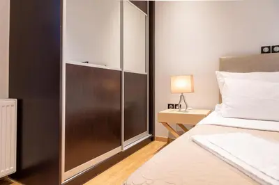 a bedroom with a bed and a glass door at Plaka Sweet House 1 in Athens