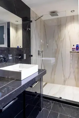 a bathroom with a white sink and a mirror at Plaka Sweet House 1 in Athens