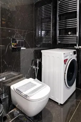 a bathroom with a toilet and a washing machine at Plaka Sweet House 1 in Athens