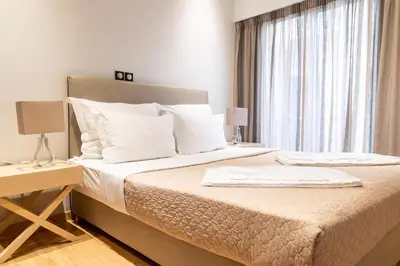 a bedroom with a large bed and a window at Plaka Sweet House 1 in Athens