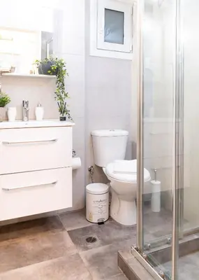 a bathroom with a toilet and a glass shower at Syntagma Sweet House in Athens