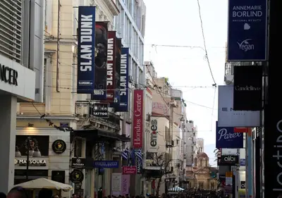 a busy city street with many signs on buildings at Syntagma Sweet House in Athens