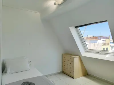 a small bedroom with a window and a bed at KYMA Apartments - Athens Acropolis 15 in Athens