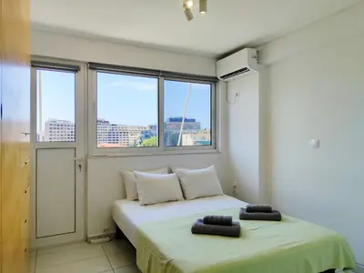 two beds in a room with two windows at KYMA Apartments - Athens Acropolis 15 in Athens